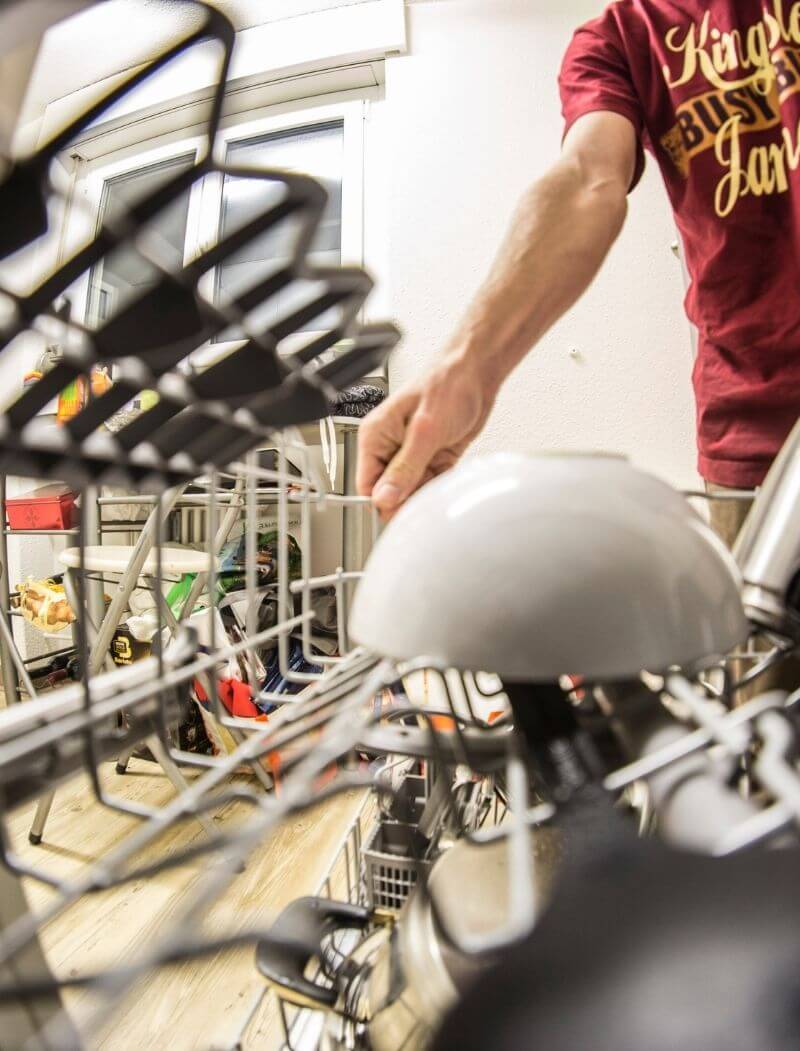 man putting bowl in a dishwasher