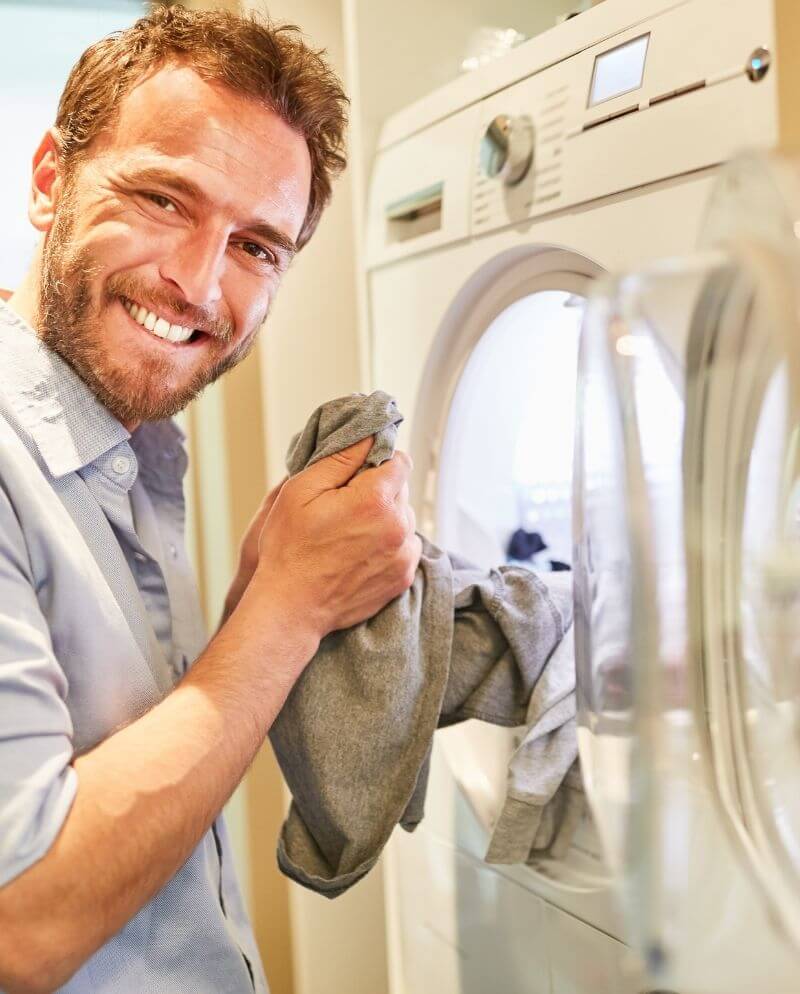 man using clothes dryer